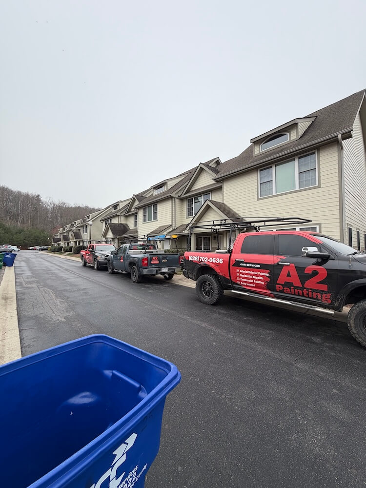 a2 painting branded trucks in front of hendersonville painting project