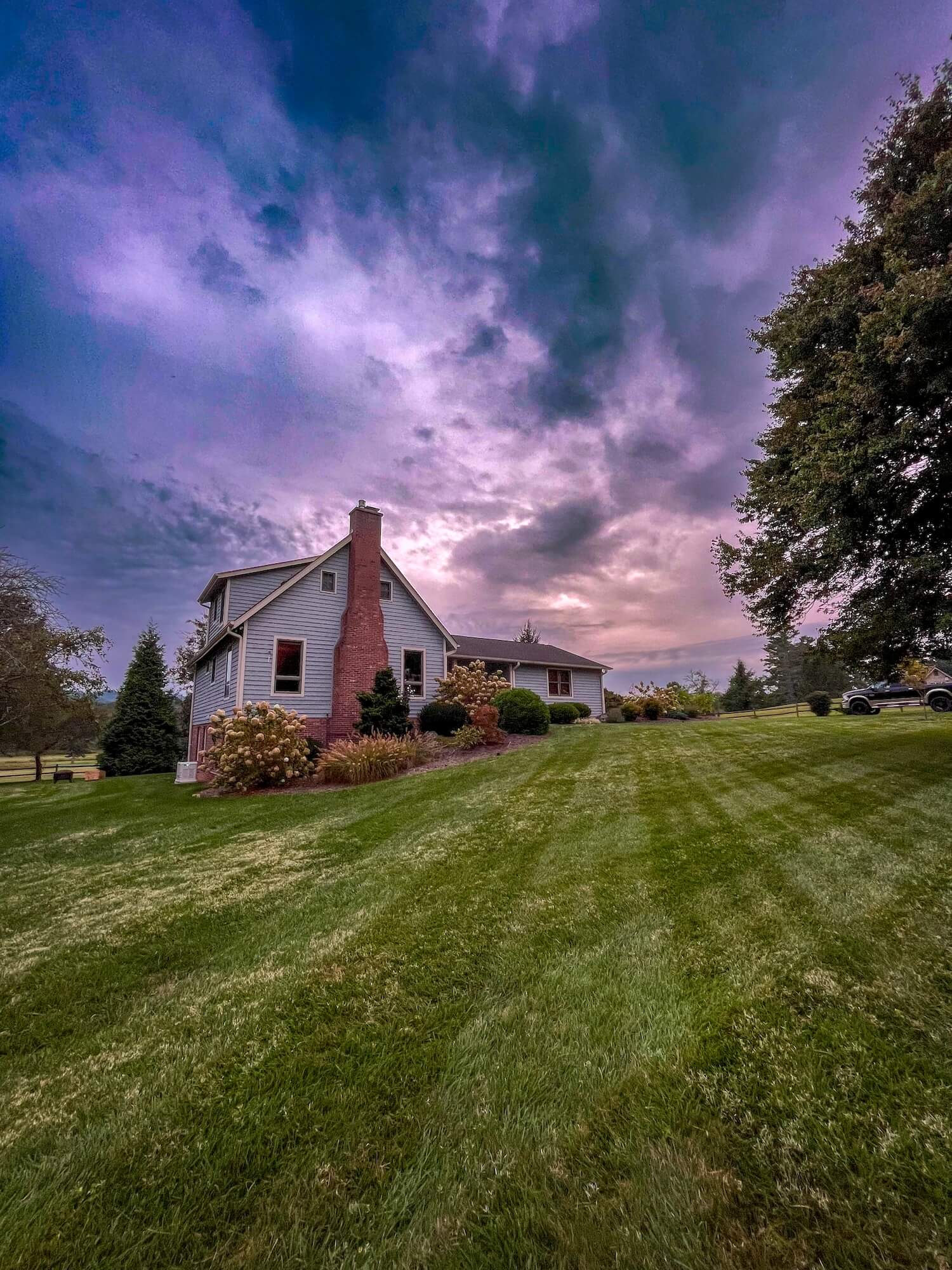 professionally painted home exterior in hendersonville nc in front of sunset