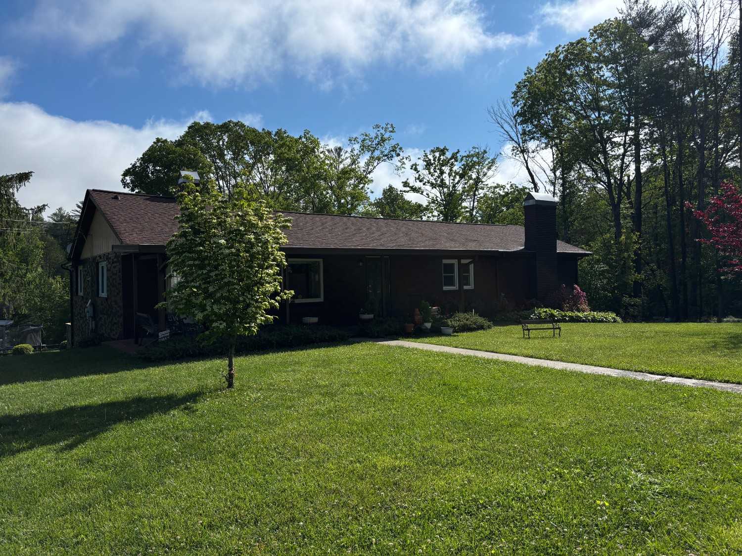 dark brown home exterior on green lawn in Western North Carolina