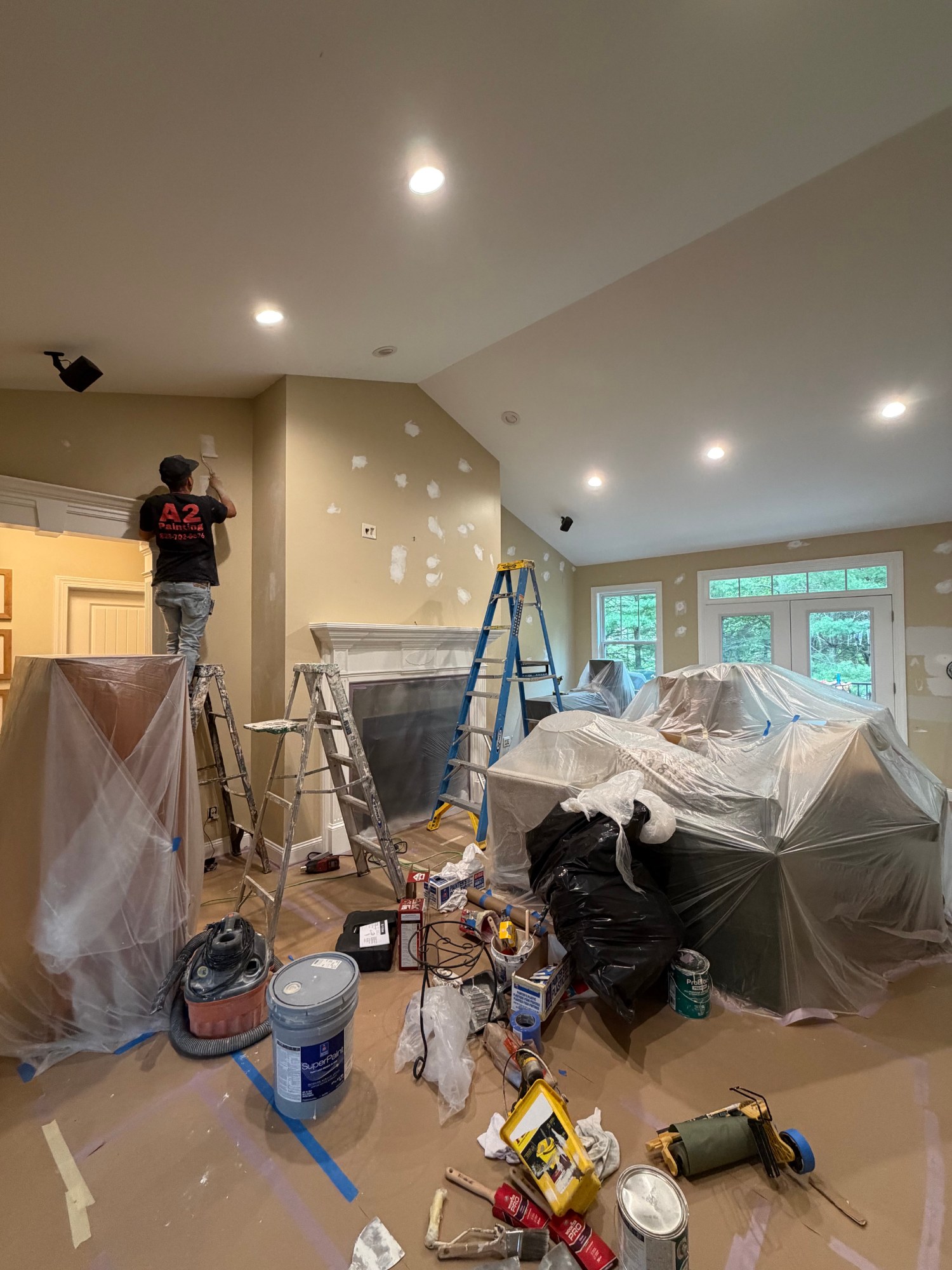 A2 Painting crew member painting a vaulted great room ceiling