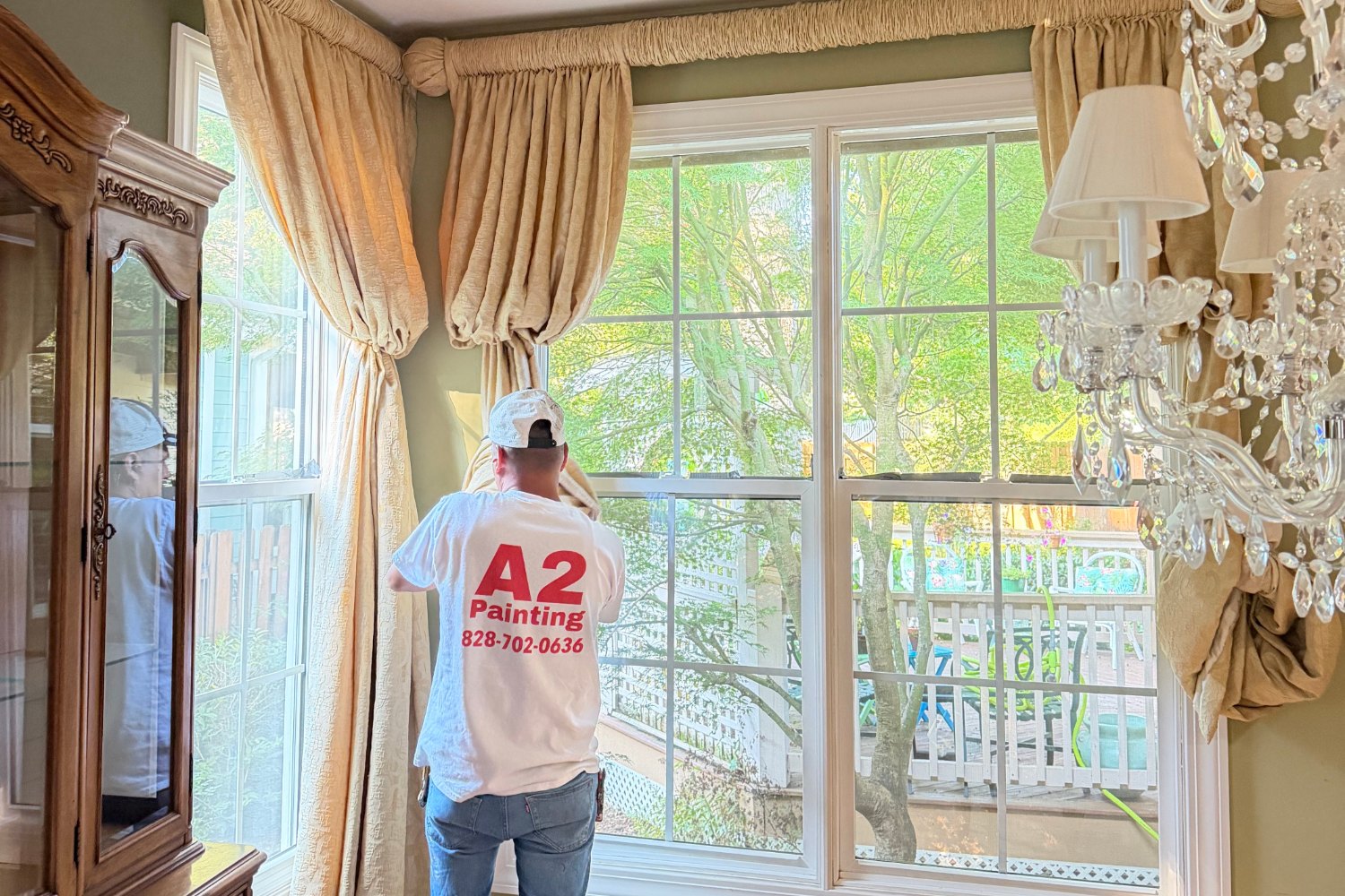 A2 Painting painter in branded shirt working in a formal dining room