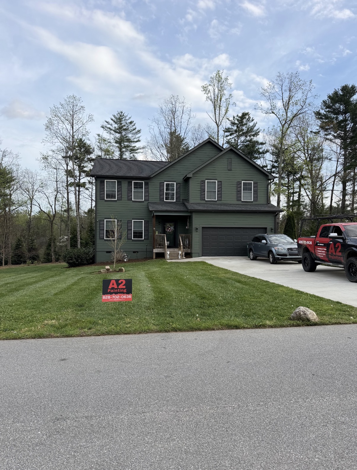 Two-story home with fresh deep green exterior paint and white trim