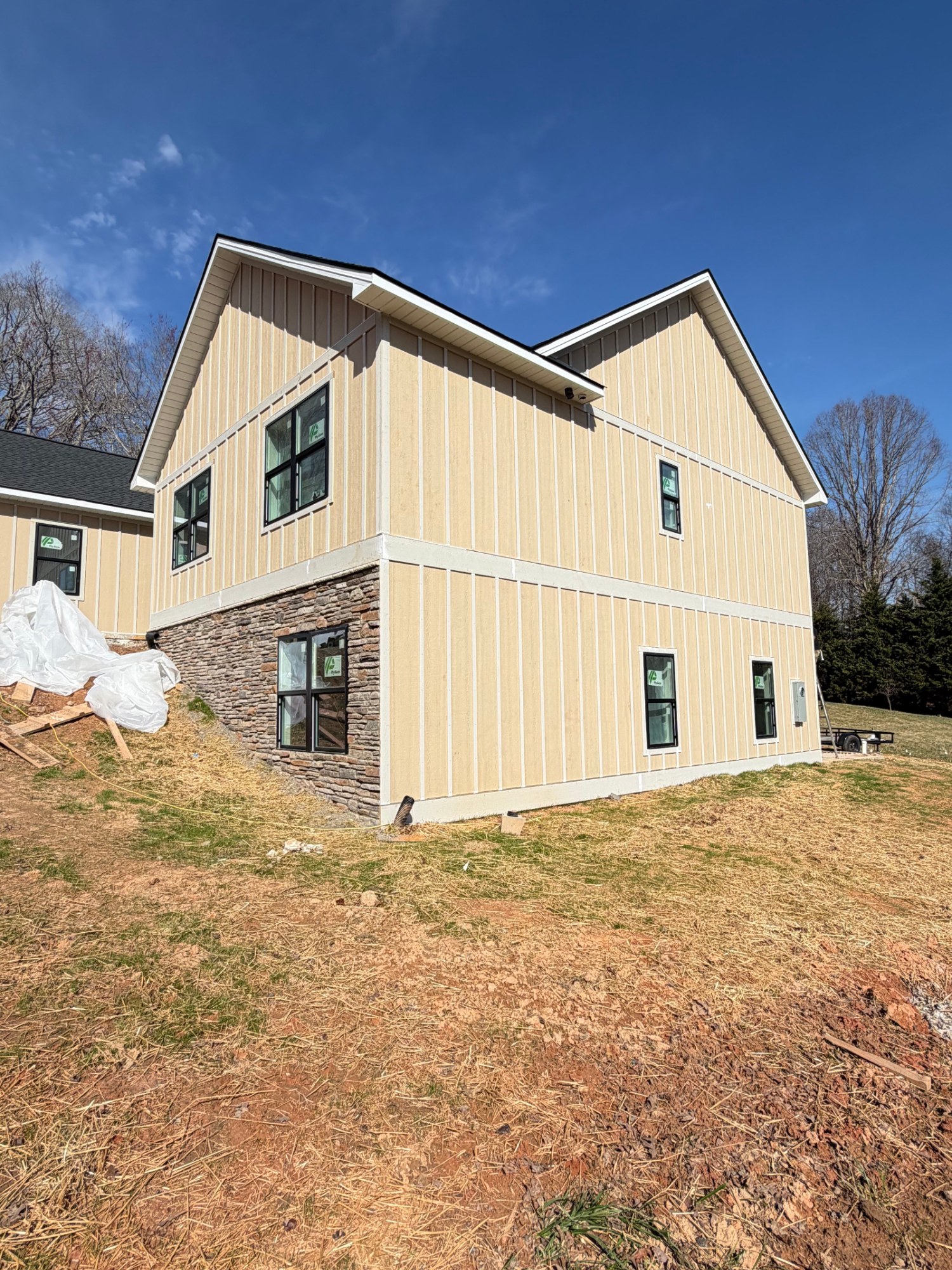 Two-story home with fresh board and batten exterior paint finish
