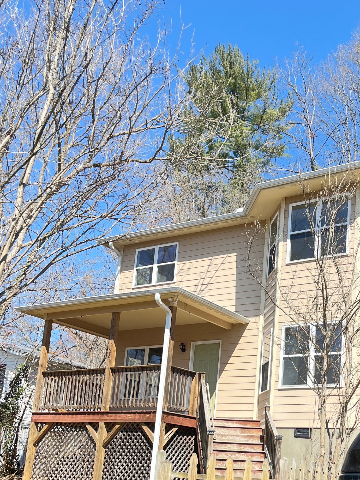 Two-story home exterior repaint with covered porch and deck