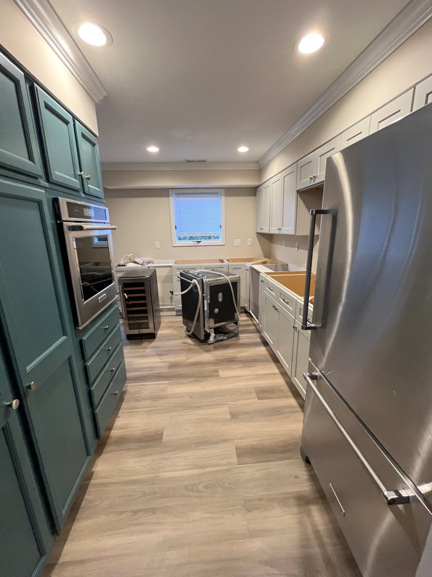 Spacious kitchen with green cabinets after interior painting